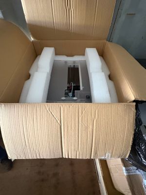a cardboard box with a water tank inside of it