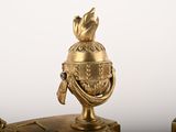 two gold statues of a man and a woman on top of a table