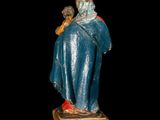 an image of a statue of a woman sitting on top of a wooden block