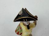 a figurine of a man with a hat on his head