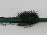a green umbrella with a black handle on a white surface