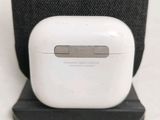 a white apple airpods sitting on top of a black stand