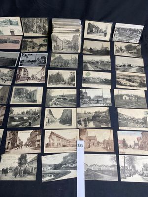 several old postcards of different types and sizes are on a table