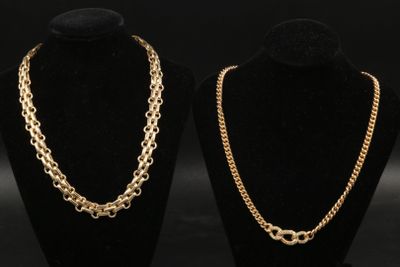 two gold chains on display in a black display case