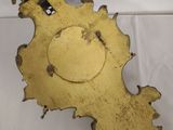 antique brass clock face with a bird on top of it