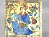 a picture of a tile with a woman sitting on it