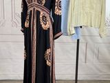 two dresses on a mannequin stand in front of a white wall