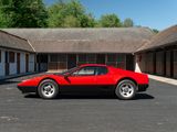 a red sports car parked in front of a building