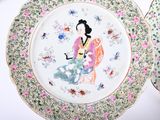 two plates with a woman on them on a table