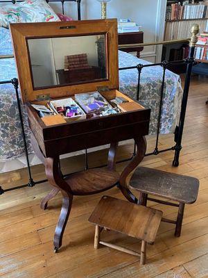 un petit bureau avec un miroir et une chaise dans la pièce