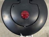 a picture of a black round object with a red light