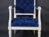 a white chair with blue velvet upholstered seat