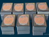 several stacks of cards sitting on top of each other on a table