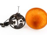 an orange bowl and a black lamp on a white surface