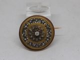 a close up of a button with a flower on it