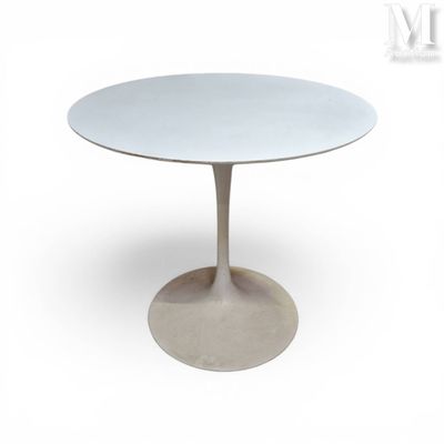 the table is white and has a circular base