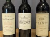 trois bouteilles de vin sont alignées sur une table en bois