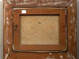 an old picture frame with a piece of fabric hanging on a wall