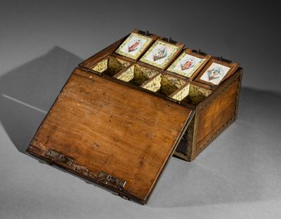a small wooden box with cards in it on a table