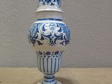 a blue and white vase with a lid on a table