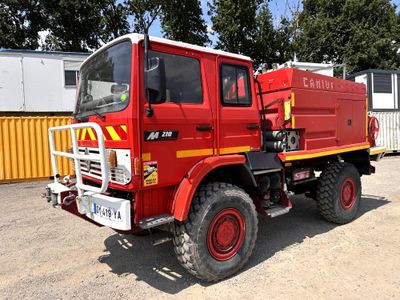 a red fire truck that is parked in a lot
