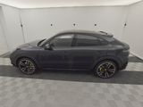 a grey porsche cayen is parked in a garage