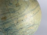 a person that is holding a globe in their hand