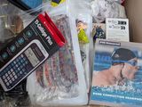 a box full of assorted items that include a cell phone, a cell phone case, and other items
