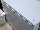 a white refrigerator sitting in a kitchen next to a sink