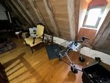 a room with a chair, a chair, and a table in it