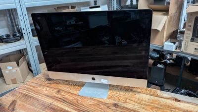 a computer monitor sitting on top of a wooden desk