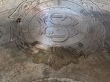 a silver plate with a design on it on a table