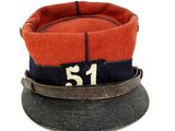 a red and blue hat with a number on it