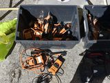 two bins filled with orange and black items on the ground