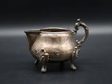 an antique silver plated bowl with handles and handles on a black surface