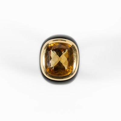 a close up of a ring with a large brown stone in it