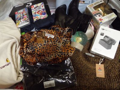 a pile of clothes and other items on a bed