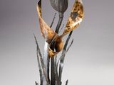 a metal sculpture of a flower on a table