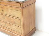 a marble top chest of drawers in the corner of a room