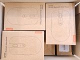 three boxes of wii remotes in a cardboard box on top of a table