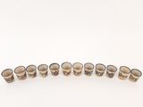 a set of six shot glasses sitting on top of a white surface