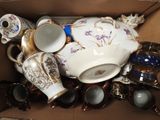 a box filled with many different types of tea cups and saucers