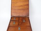 an old wooden box with four compartments on a white surface