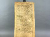 a large piece of paper with writing on it sitting on a stand