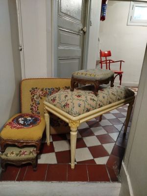 a couch, chair, ottoman, and table in a hallway