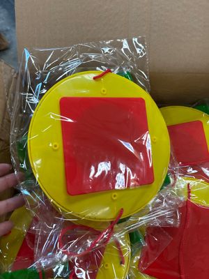a person holding a yellow and red toy in a box