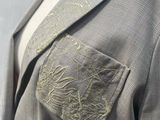 an image of a mannequin wearing a jacket and tie