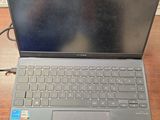 a laptop computer sitting on top of a wooden desk