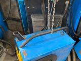 a blue machine that is sitting in the garage