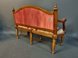 a wooden bench with a pink upholstered seat